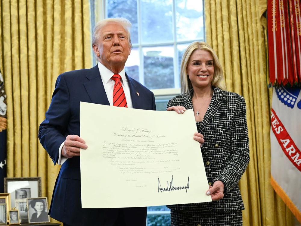 President Trump and Pam Bondi pose with the official commission signed by Trump that appoints Bondi to the position of U.S. Attorney General after she was sworn in in the Oval Office on Wednesday.