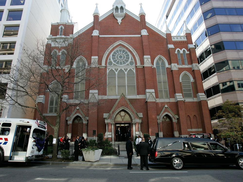 A hearse carrying the casket of Rosa Parks and a 1950s era bus sit in front of the Metropolitan AME Church where a memorial service for the civil rights icon was being held on Oct. 31, 2005, in Washington, D.C. A judge has ordered the naming rights of the extremist group the Proud Boys be given to the church.