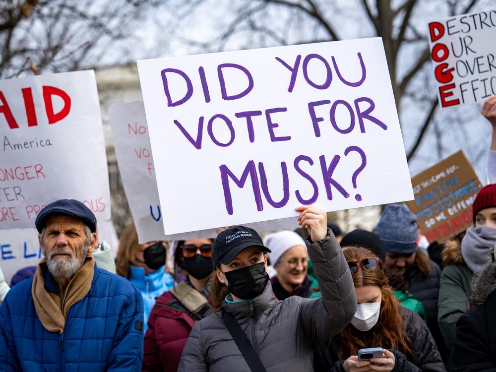 Protesters carried signs blaming tech billionaire Elon Musk for what critics have called the unconstitutional dismantling of USAID.