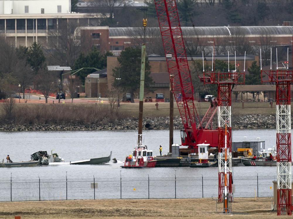 Rescue and salvage crews work near the wreckage of an American Airlines jet in the Potomac River near Ronald Reagan Washington National Airport on Sunday, Feb. 2, 2025, in Arlington, Va.