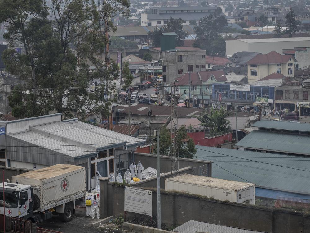 Red Cross personnel load bodies of victims of the fighting between Congolese government forces and M23 rebels in a truck in Goma, Monday as the U.N. health agency said 900 died in the fight.