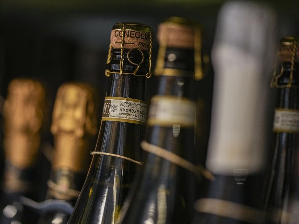 Bottles of Prosecco are lined up on a shelf of a wine shop in Rome, Thursday.