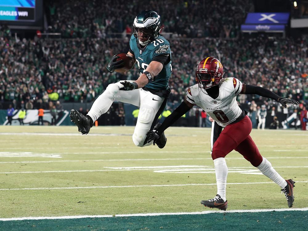 Saquon Barkley of the Philadelphia Eagles scores a touchdown against the Washington Commanders during the fourth quarter in the NFC Championship Game on Jan. 26.