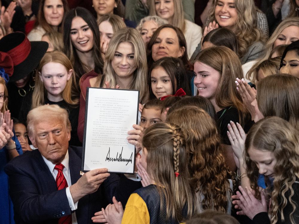 President Trump holds up the 