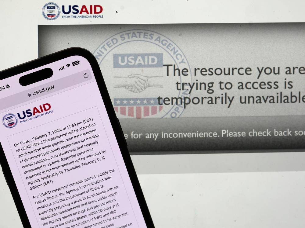 In this photo illustration, a message appears on the U.S. Agency for International Development (USAID) website on Feb. 5. The Trump administration issued a directive late Tuesday night that all USAID direct hire personnel will be placed on administrative leave globally Friday at midnight.