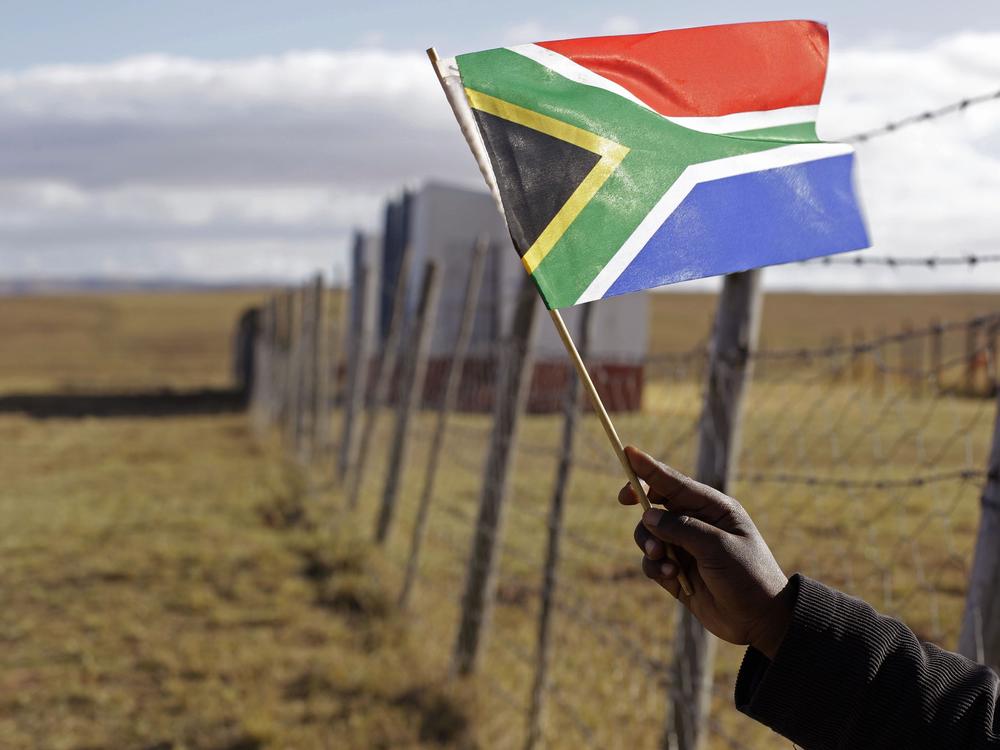 A child holds a flag at the No-Moscow school in Qunu, South Africa, in 2012.