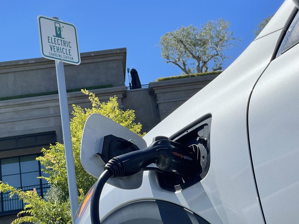 An electric car charges at a mall parking lot on June 27, 2022 in Corte Madera, California.