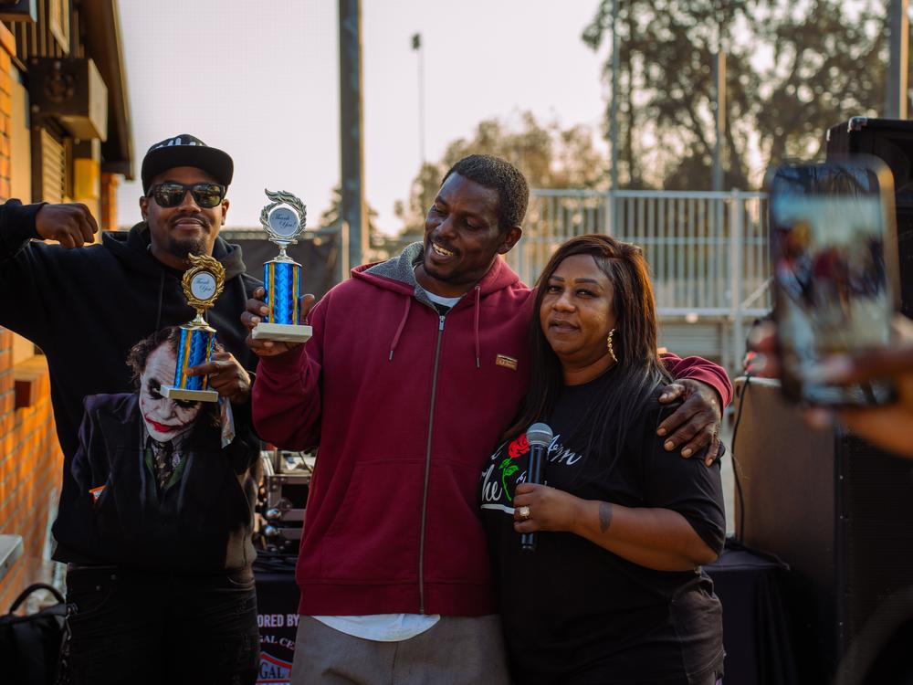 Latoya Carr, right, hands out awards to Cedrick Jolley, left, and Andre Brown at Robinson Park Recreation Center at Dena Love Day on Jan. 19, 2025. Jolley and Brown were volunteers helping victims of the Eaton Fire.