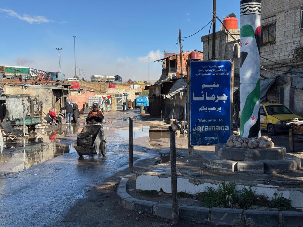 A worker walks through the muddy streets of the Jaramana Camp on the edge of Damascus. About 13,000 Palestinian refugees live in the camp.