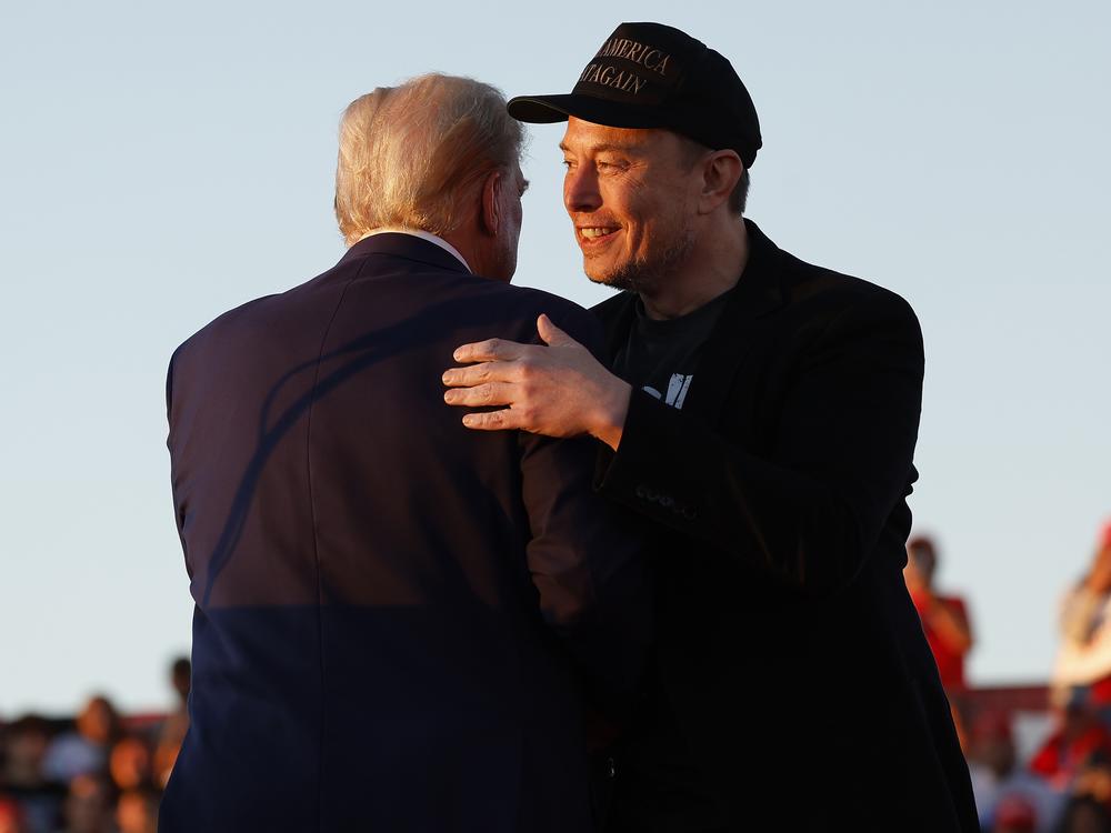 President-elect Donald Trump, left, and Elon Musk embrace at a rally in October 2024.