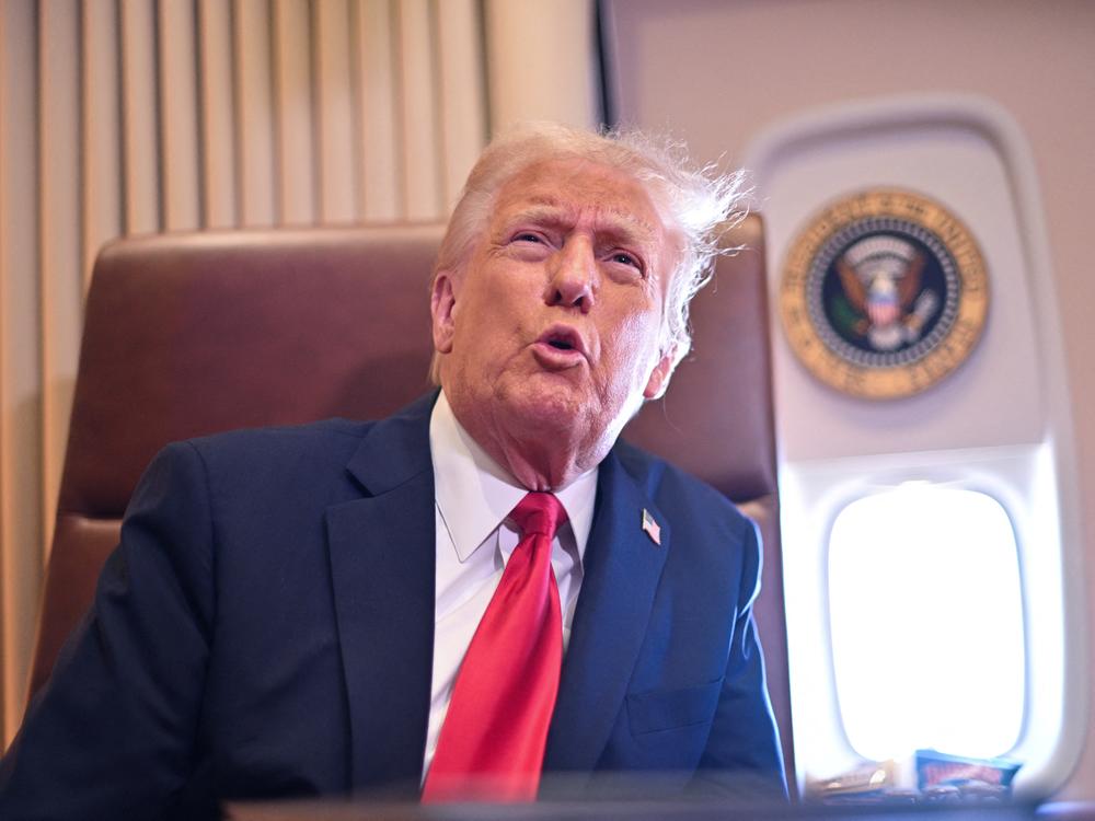 President Trump speaks to the press aboard Air Force One on Sunday.