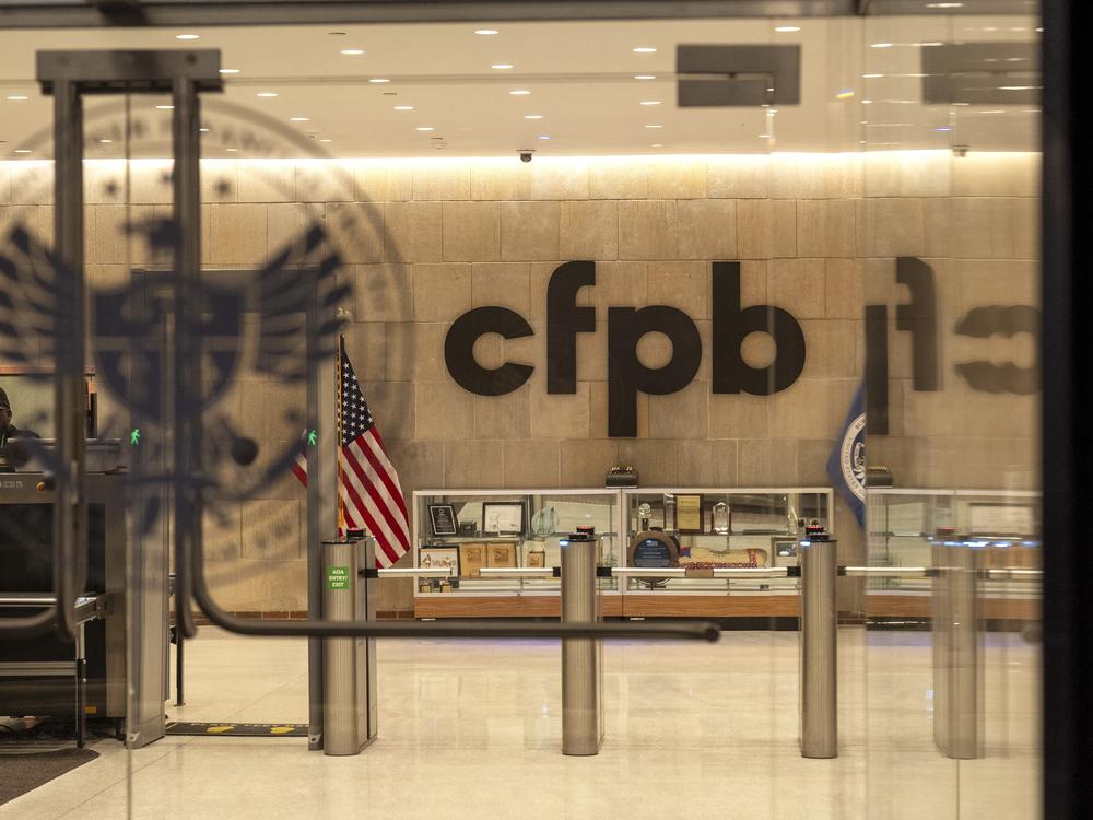 A security officer works inside of the Consumer Financial Protection Bureau (CFPB) building headquarters on Monday in Washington. Staff and contractors have been told the building is closed for the week, and to perform no work.