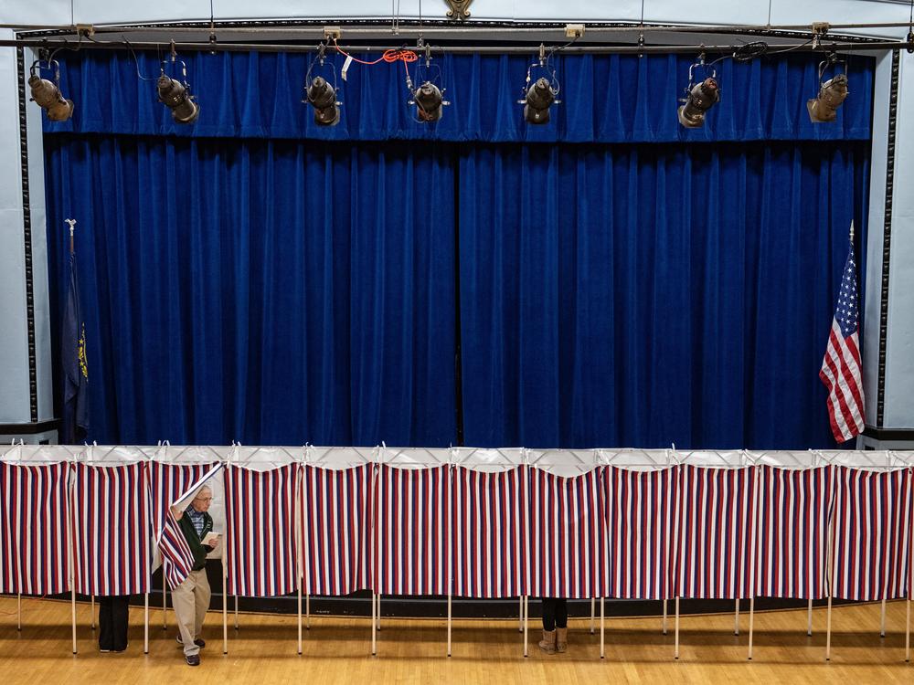 A man exits a voting booth at a polling station in Lancaster, N.H., on Election Day, Nov. 5.