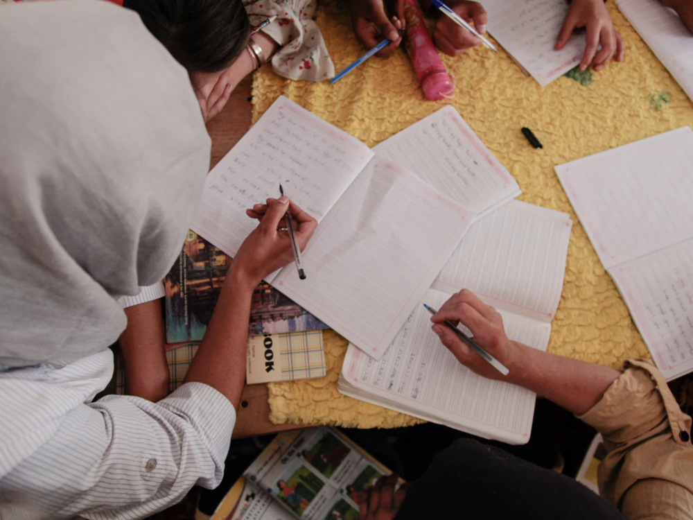Teenage girls take notes in an English class in a small secret school for girls on the outskirts of Kabul. USAID funds have helped support such schools in Afghanistan. The funding is now on hold as part of a freeze on foreign aid.