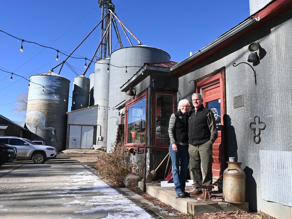 Tammie (left) and Patrick Delaney pose in front of the Wild Goose coffee shop in Hayden, Colo., in November 2024. The Delaneys have concerns about the idea of using trains to import spent nuclear fuel to northwest Colorado.