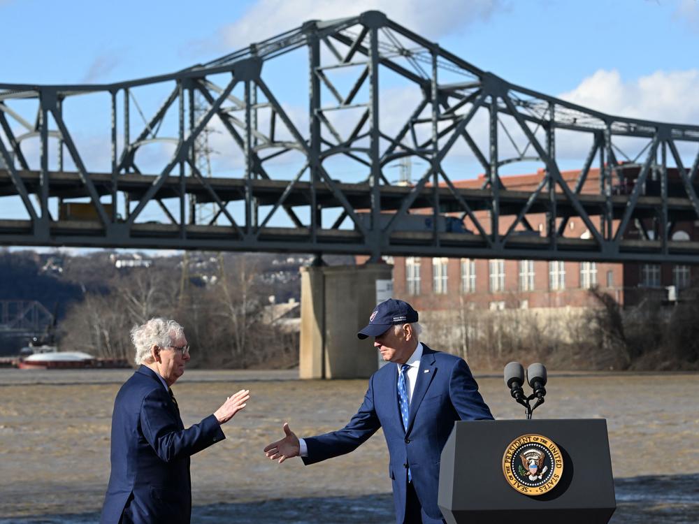 Former President Joe Biden shakes hands with Republican Sen. Mitch McConnell during an event related to the Bipartisan Infrastructure Law in Covington, Ky., in 2023.