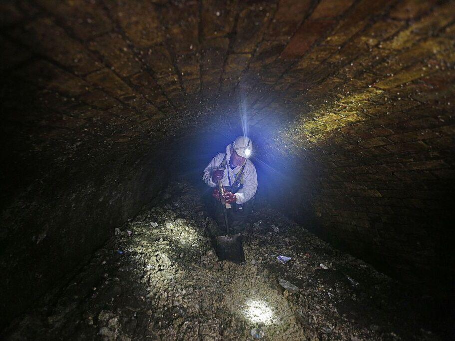 A London city worker clears up a fatberg in 2014. A fatberg in Australia caused the cancellation of a concert over the potential for wastewater overflow.