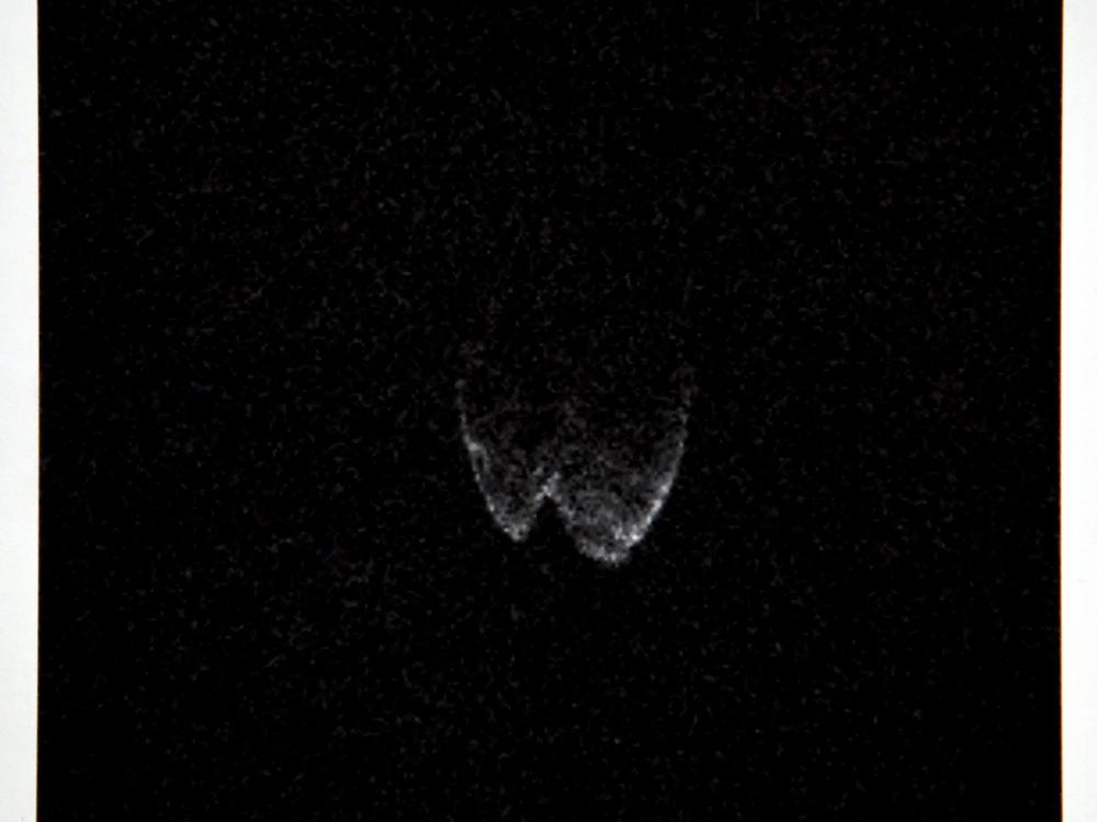 A radar image of asteroid 2014 JO25 from a radio telescope at the Arecibo Observatory/NASA/NSF in Puerto Rico taken on April 17, 2017, is shown on a screen by a member of the Las Vegas Astronomical Society outside the Planetarium at the College of Southern Nevada on April 19, 2017, in North Las Vegas, Nev.