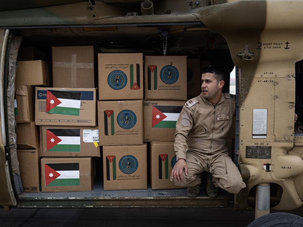 A Black Hawk helicopter is seen ready for takeoff, carrying critical supplies as part of Jordan's ongoing humanitarian air bridge to the Gaza Strip.