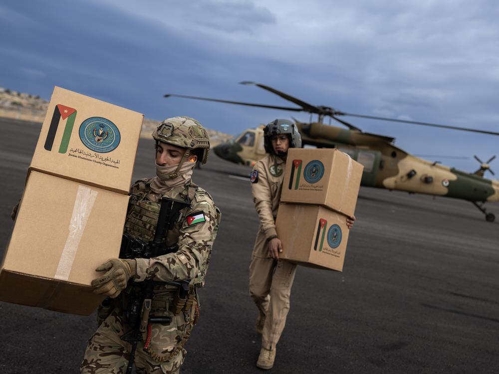 The Royal Jordanian Air Force's 8th Squadron unloads humanitarian aid at a helipad in Gaza.
