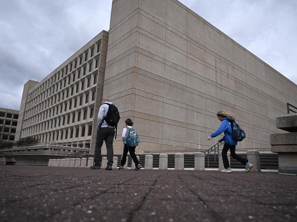 People walk past the U.S. Department of Energy building in Washington, D.C.
