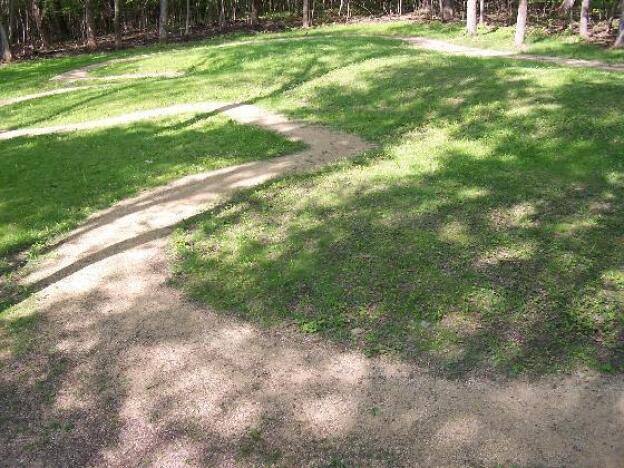 Little Bear Effigy Mound is pictured at the Effigy Mounds National Monument in 2004. The mound shows a four-legged animal and is outlined in small pebbles.