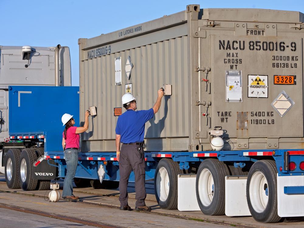 Two employees from the National Nuclear Security Administration use gamma detectors to test the outside of a container of highly-enriched uranium for surface contamination at the Charleston Weapons Station near Goose Creek, S.C. on March 19, 2010.