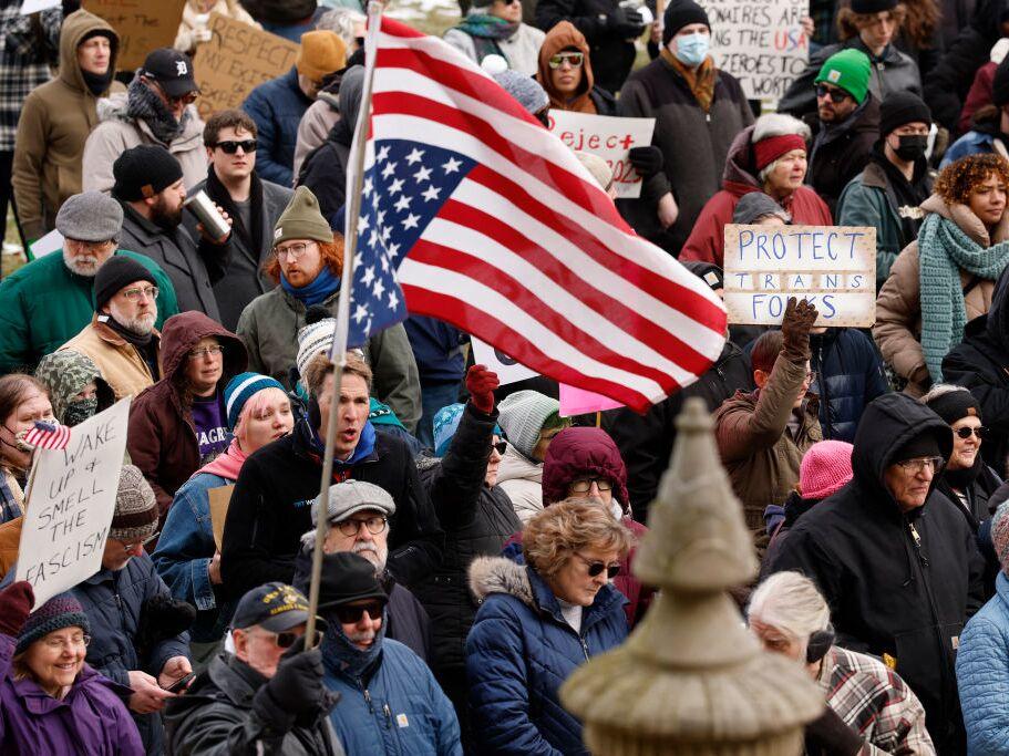People protest against President Donald Trump and Elon Musk outside the Michigan Capitol in Lansing, Mich., on Feb.5.