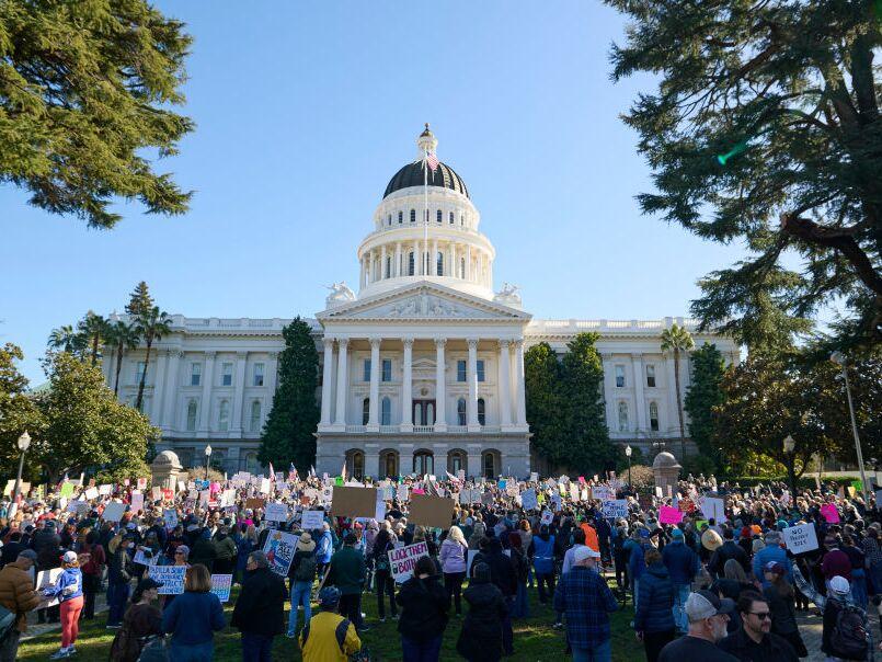 Crowds gather in front of the California Capitol Building during the 