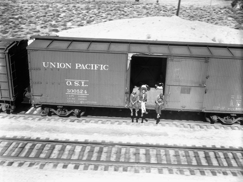 Hobos ride a freight car to Southern California in 1934.