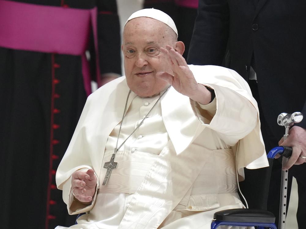 Pope Francis waves as he arrives for his weekly general audience in the Paul VI Hall, at the Vatican, Wednesday, Feb. 12, 2025.
