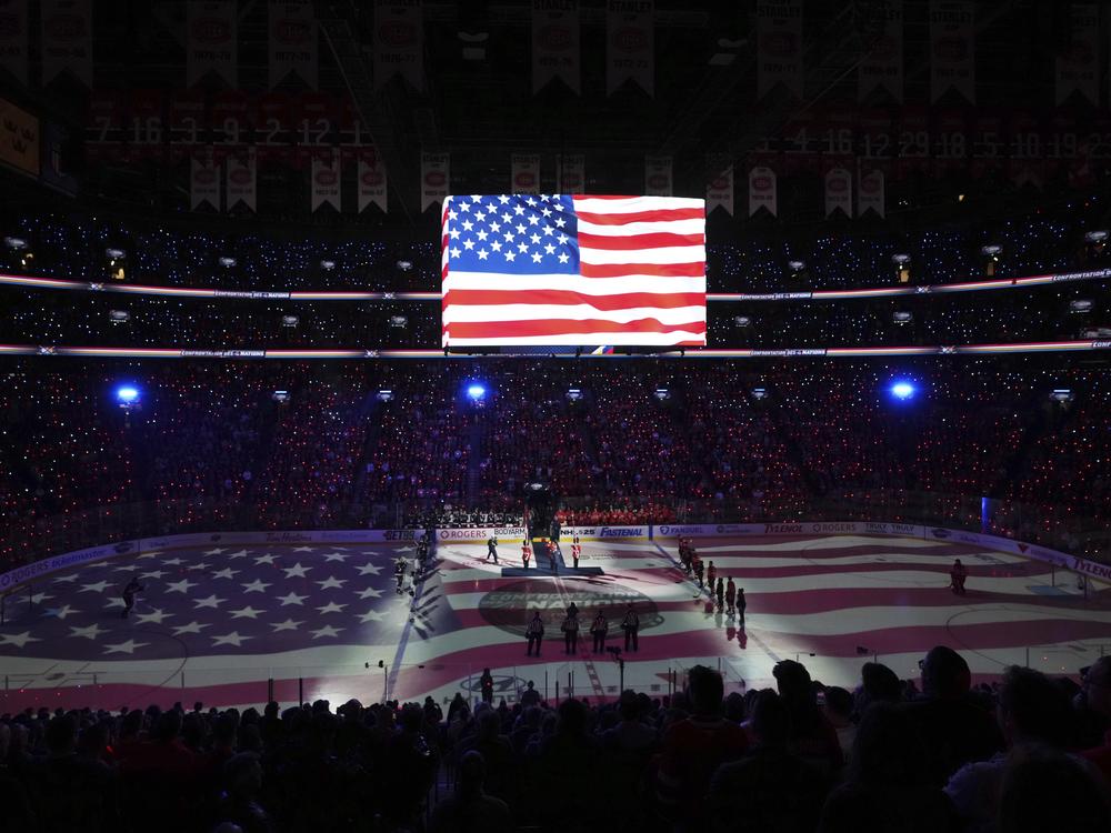 Players and fans stand for the U.S. national anthem prior to the first period of 4 Nations Face-Off hockey game between Canada and the United States in Montreal on Saturday, Feb. 15, 2025.