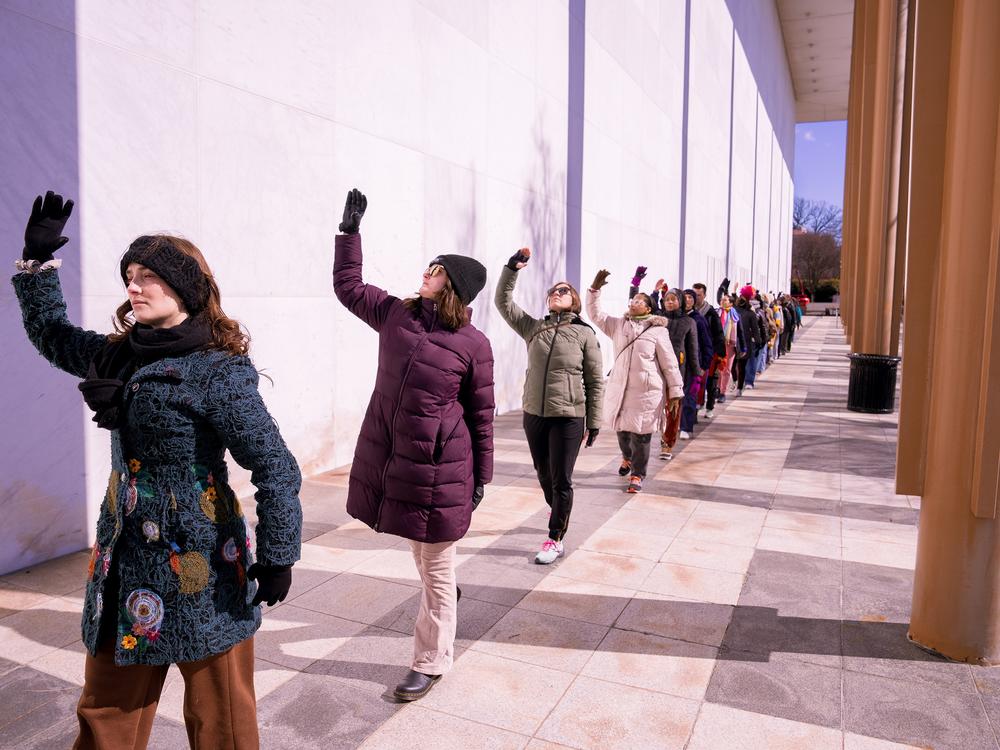 Performers dance outside of the Kennedy Center in Washington, D.C., on Monday. The dance was part of a protest against new leadership by President Trump.