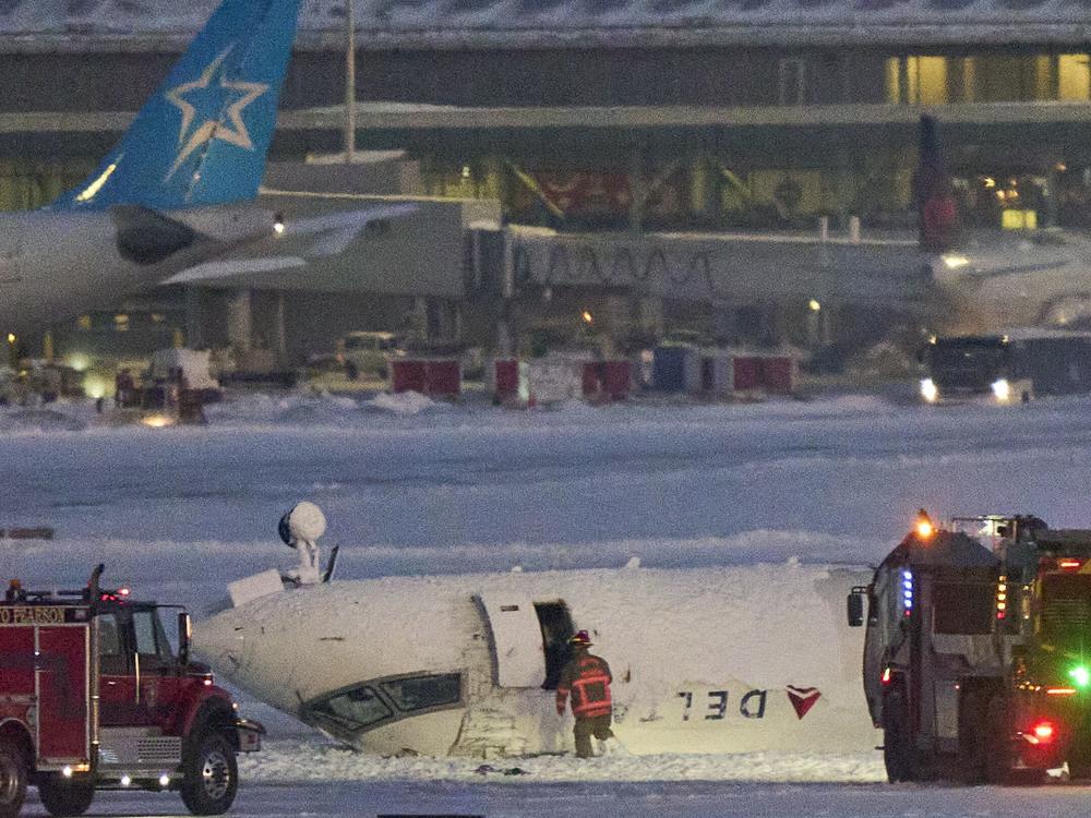A Delta air Lines plane sits on its roof after crashing upon landing at Toronto Pearson Airport in Toronto, Ontario, on Feb. 17, 2025.