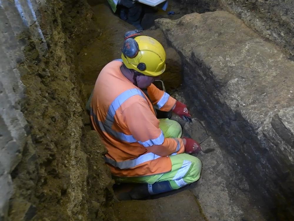 An archaeologist is seen on a screenshot from a video of an excavation in the basement of a building on Gracechurch Street in London's financial district.