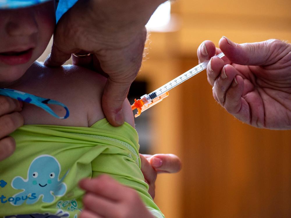 A 3-year-old receives a COVID-19 vaccine on June 21, 2022.