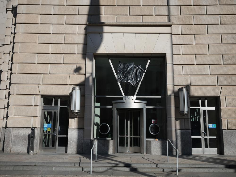 Workers removed the sign at the U.S. Agency for International Development building on February 7.
