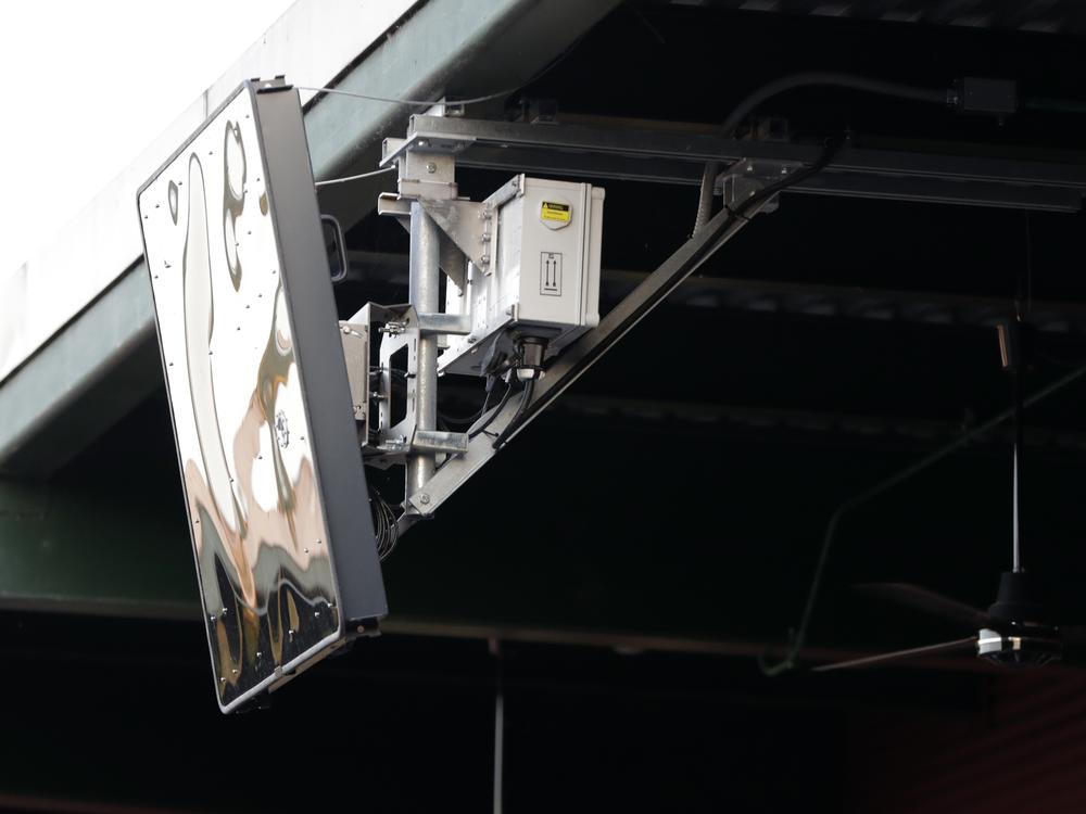 A radar device is seen on the roof behind home plate at PeoplesBank Park during the third inning of an Atlantic League All-Star minor league baseball game in York, Pa. Baseball's top minor leagues are switching to a challenge system full-time for their test of robot umpires. Major League Baseball has been experimenting with the automated ball-strike system in the minor leagues since 2019 and is trying it at spring training for the first time this month.