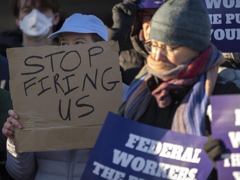 Demonstrators rally in support of federal workers outside of the Department of Health and Human Services in Washington, D.C. on Friday, amidst a wave of mass layoffs across the federal government.