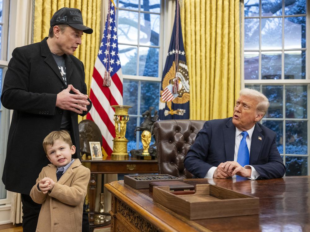 Tesla and SpaceX CEO Elon Musk with his son X Æ A-Xii and President Trump in the Oval Office on Feb. 11. Musk has been tapped by President Trump to lead federal cost-cutting efforts.