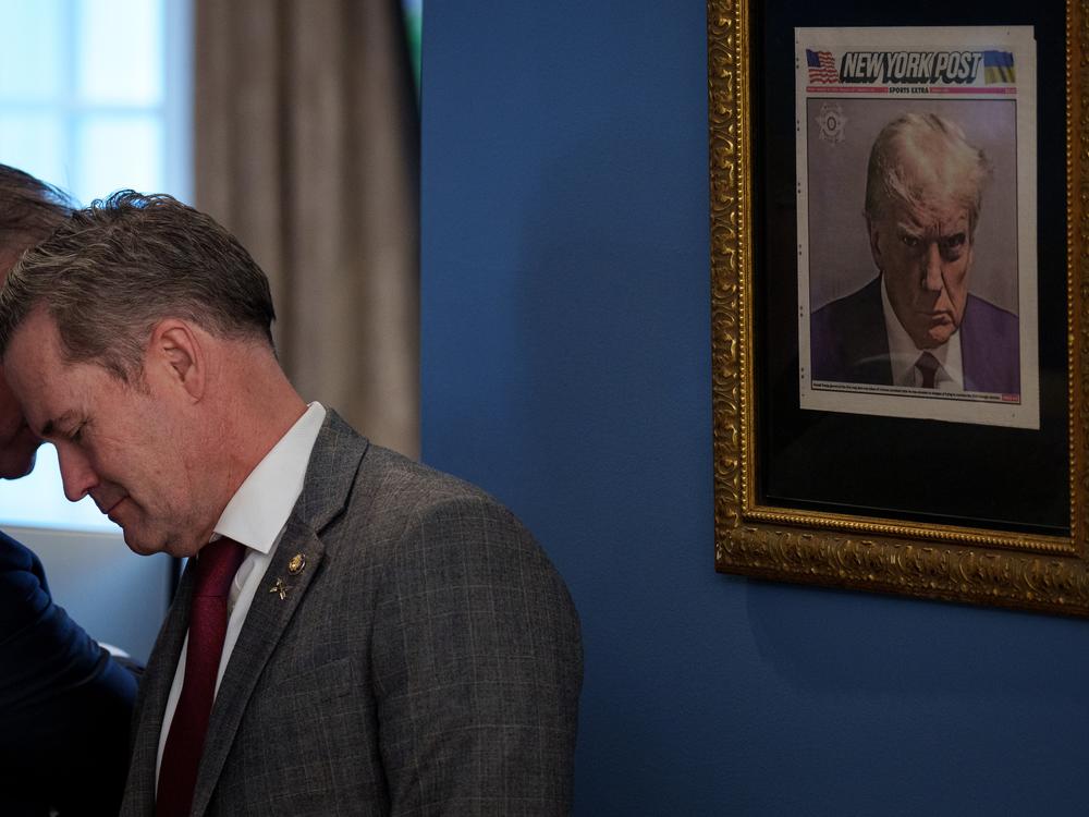 A copy of Donald Trump's mug shot on the cover of the <em>New York Post</em> is framed in an office just outside the Oval Office.
