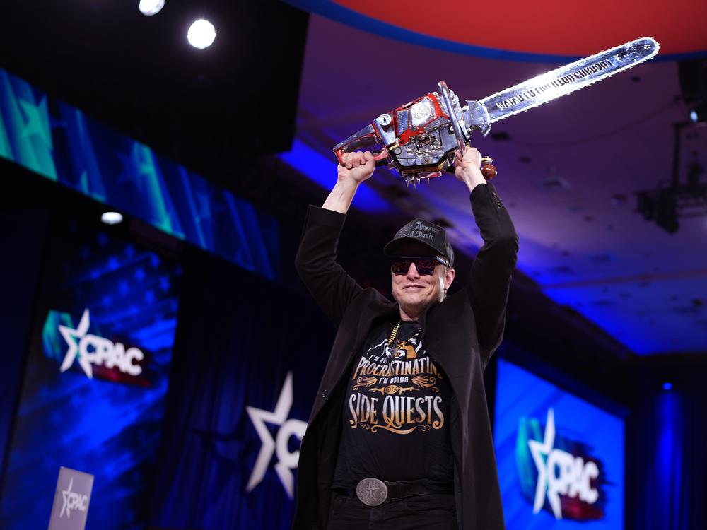 CEO of Tesla and SpaceX Elon Musk, head of the Trump administration's team tasked with slashing the size of the federal government, leaves the stage holding a chainsaw after speaking at the Conservative Political Action Conference (CPAC) on Feb. 20 in Oxon Hill, Md.