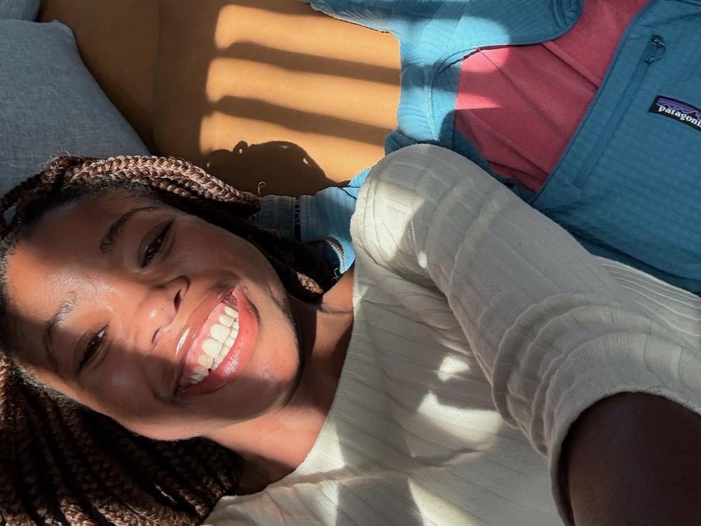 Kiah (foreground) and Adrian pose for a selfie in bright natural light. He says she had 