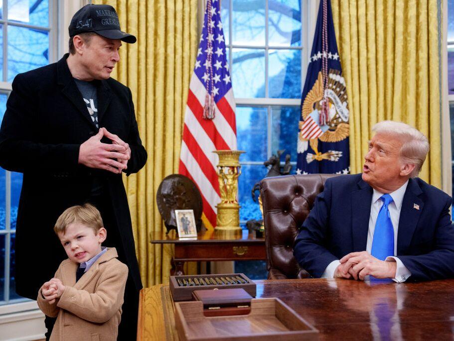 President Trump is joined by Tesla and SpaceX CEO Elon Musk, and his son, X Musk, during an executive order signing in the Oval Office at the White House on Feb. 11.