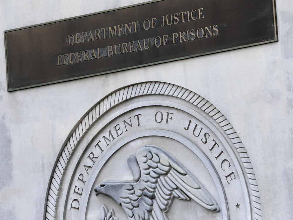 A sign for the Department of Justice Federal Bureau of Prisons is displayed in the Brooklyn borough of New York, July 6, 2020.