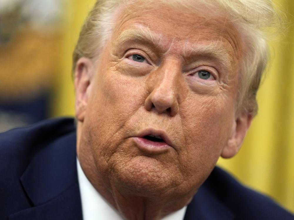 President Donald Trump talks to reporters as he signs executive orders in the Oval Office of the White House on Jan. 23, 2025, in Washington.