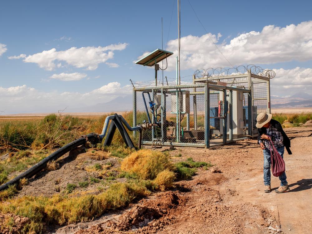 Sara Plaza member of the indiginous community of Peine, walks near a water extraction well in Tilopozo, a former wetland.