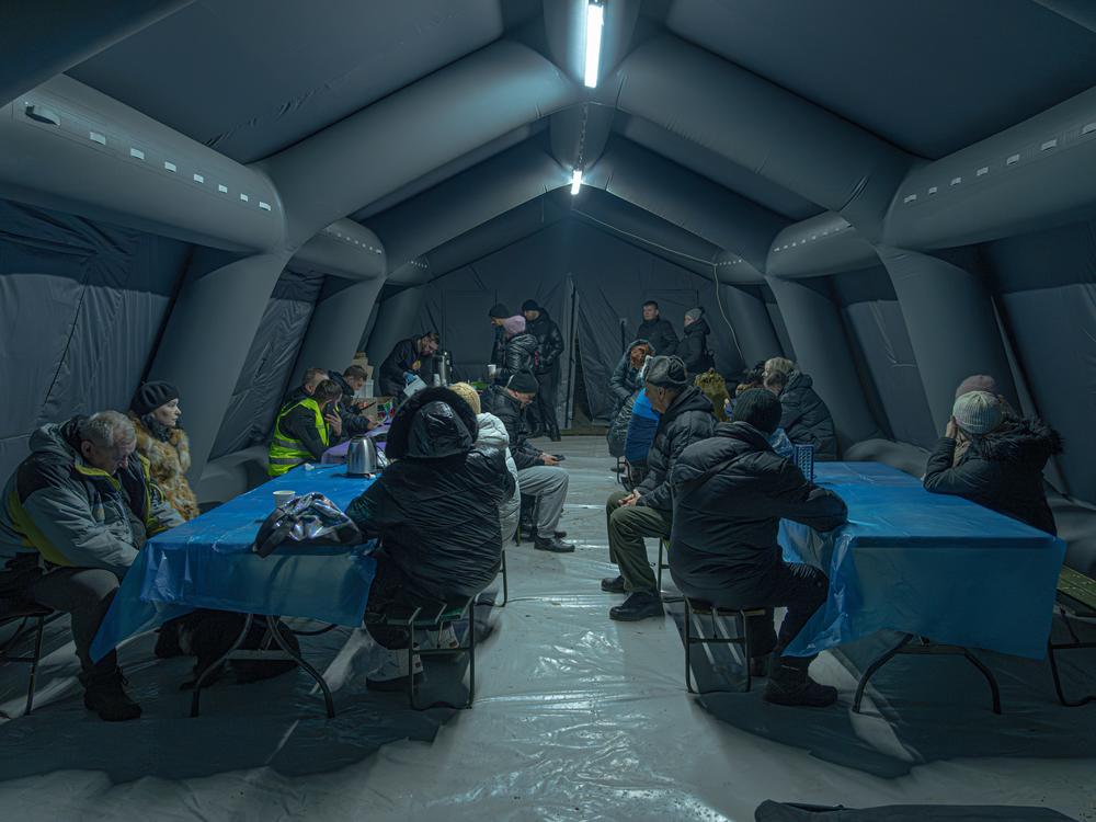 Sumy residents wait in a rescue tent after a Russian drone attack, Jan. 30.