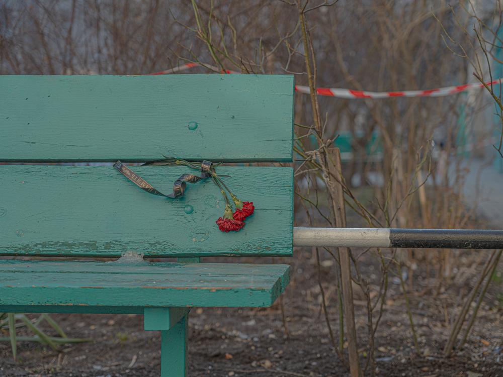 Flowers on a bench in memory of those killed in a Russian drone strike on a residential building in Sumy, Jan 30.