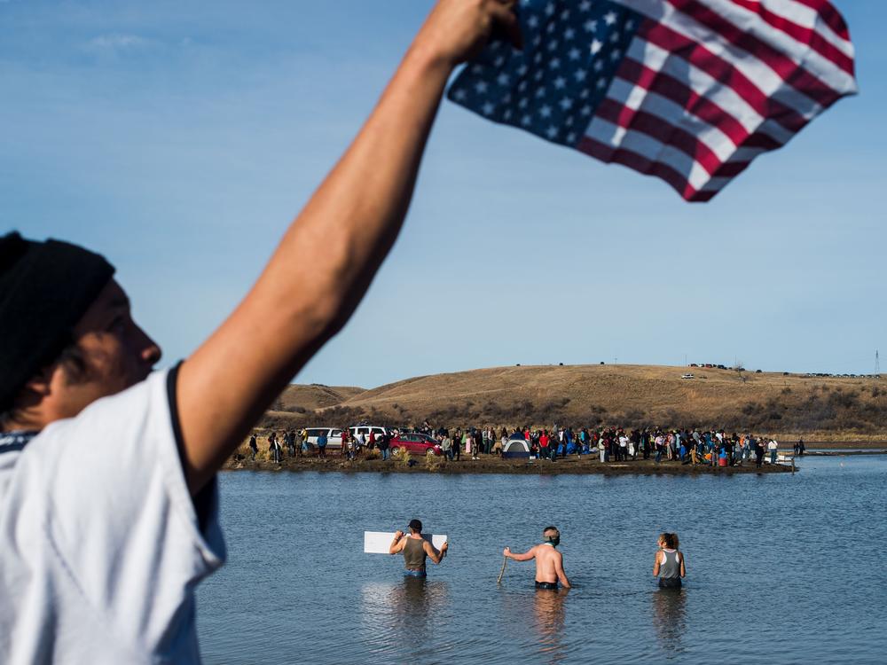 Protesters wade in the Cannon Ball River during a standoff with the police at Turtle Island north of the Standing Rock Reservation in North Dakota, on Nov. 2, 2016.